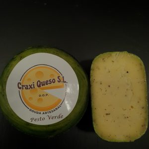Small artisan raw milk baby Gouda green pesto cheese with green pesto herbs (basil, pepper, garlic, oregano leaf, and paprika) with a cheese wheel weight of ±1 kg