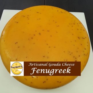 Flavourfull raw milk artisan Gouda fenugreek cheese, whole cheese wheel of Gouda farmer's cheese with aromatic fenugreek seeds